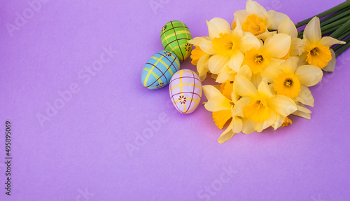 Easter layout with daffodils and eggs with space for text in the center. Place for text. Happy Easter. Banner. Greeting card. Postcard. Space for text. Close-up. Mock up.