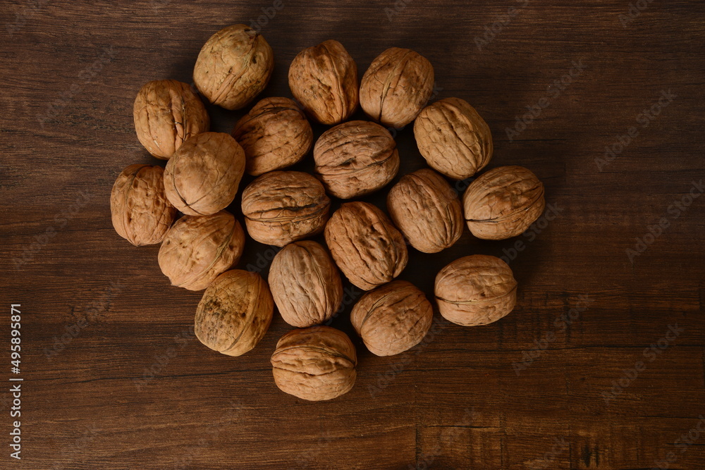 Fresh almonds in the wooden bowl, Organic almonds, almonds border white background, Almond nuts on a dark wooden background. Healthy snacks. Top view. Free space for text. Fresh almonds in the wooden bowl, Organic almonds, almonds border white background, Almond nuts on a dark wooden background. Healthy snacks. Top view. Free space for text.