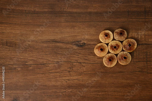 Fresh almonds in the wooden bowl, Organic almonds, almonds border white background, Almond nuts on a dark wooden background. Healthy snacks. Top view. Free space for text.