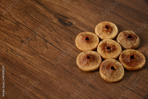 Fresh almonds in the wooden bowl, Organic almonds, almonds border white background, Almond nuts on a dark wooden background. Healthy snacks. Top view. Free space for text. photo