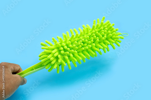 Green duster on blue background.