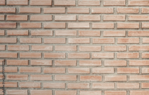 Wall of bright red brick with white seams.