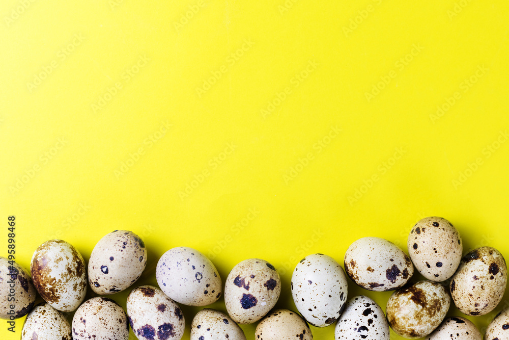 Easter greeting card with quail eggs on a yellow background