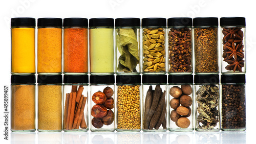 Spices, herbs, spicy and seasoning in glass jars on white background