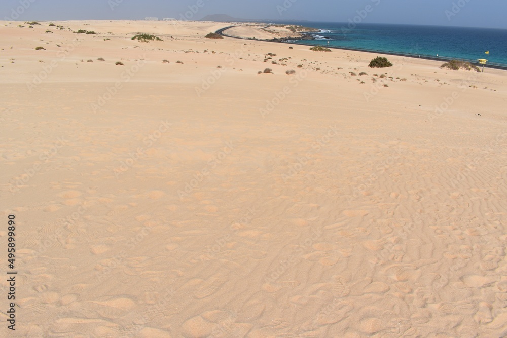 Dunes, a road, and the sea in the coast of Fuerteventura