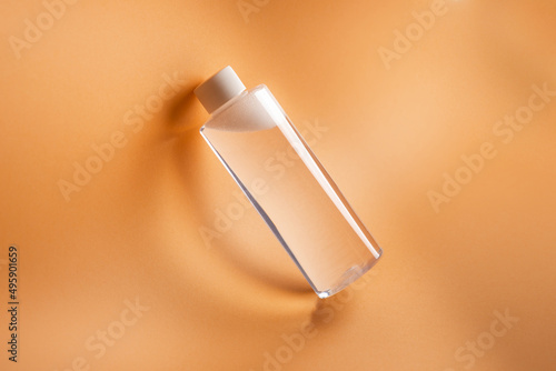 Bottle of micellar water on beige background