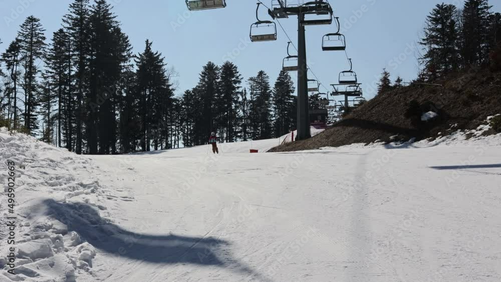 Cute toddler child in colorful ski wear, skiing in Italy on a sunny day, kids and adults skiing together. Family vacation Cute toddler child in colorful ski wear, skiing in Italy on a sunny day, kids and adults skiing together. Family vacation