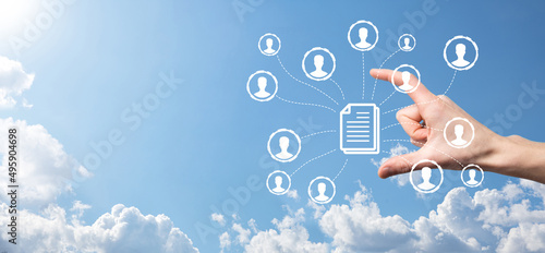 Man hold document and user icon.Corporate data management system DMS and document management system concept. Businessman click or publish on document connected with corporate users