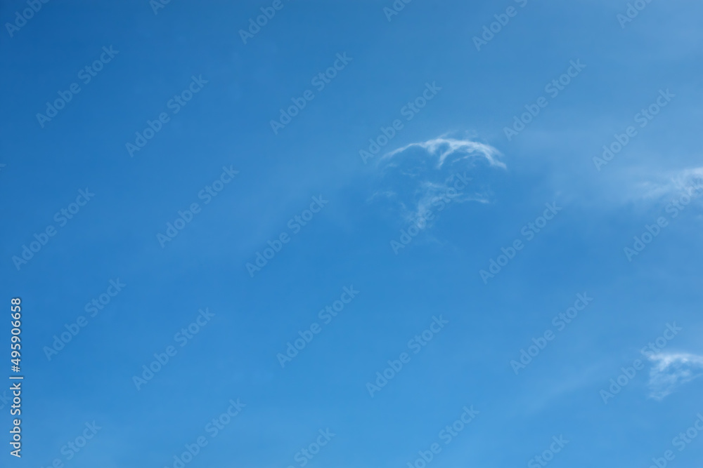 Light fluffy clouds against a clear blue sky Light fluffy clouds against a clear blue sky