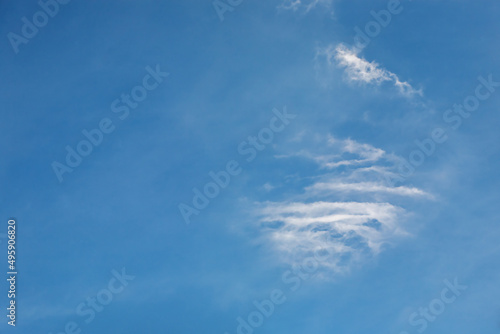 Light fluffy clouds against a clear blue sky