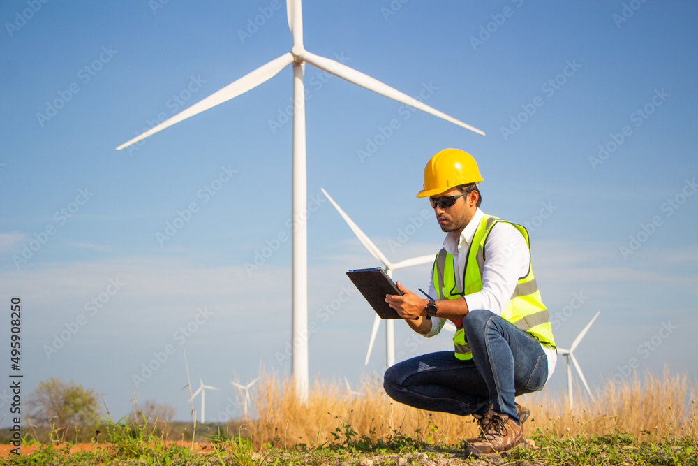 engineer team working in wind turbine farm. Renewable energy with wind generator by alternative energy concept.