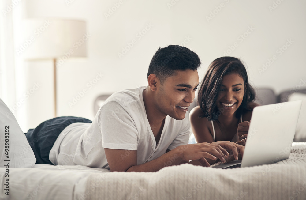 We can never decide what to watch together. Shot of a young couple using a laptop at home. We can never decide what to watch together. Shot of a young couple using a laptop at home.