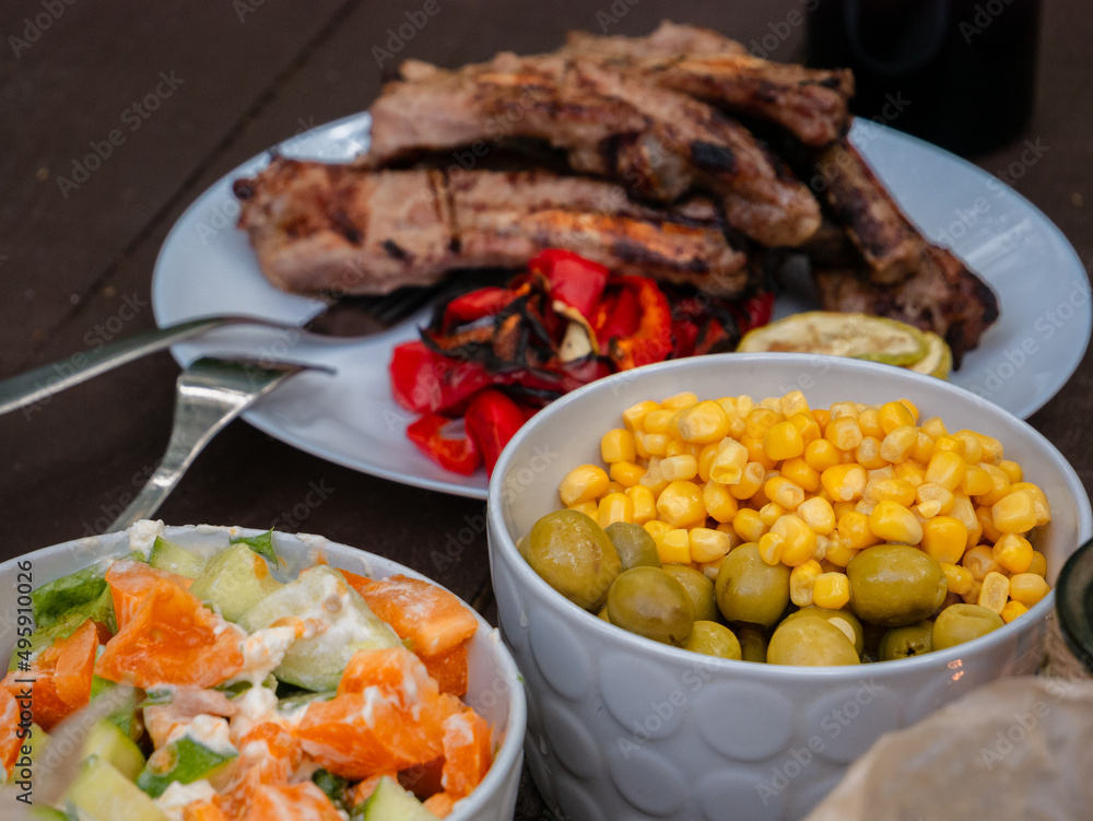 Assorted delicious grilled meat with vegetables over the coals on a barbecue Assorted delicious grilled meat with vegetables over the coals on a barbecue