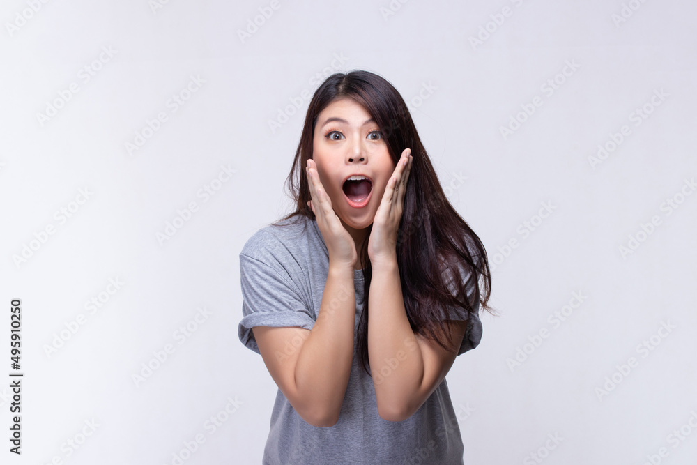 Image of feeling excited, shock, surprise and happy. Young asian woman standing on white background. Female face expressions and emotions body language concept. Image of feeling excited, shock, surprise and happy. Young asian woman standing on white background. Female face expressions and emotions body language concept.