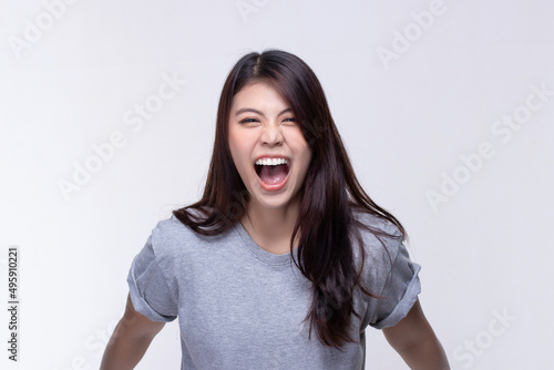 Image of feeling excited, shock, surprise and happy. Young asian woman standing on white background. Female face expressions and emotions body language concept.