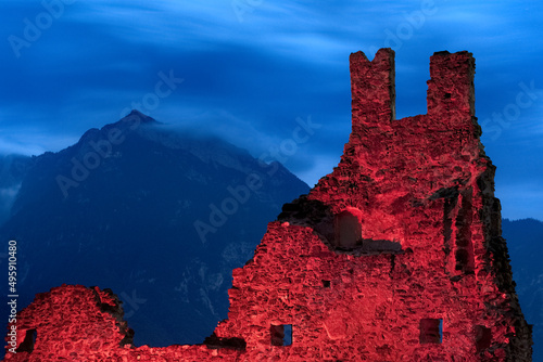 Spooky night at the Selva Castle. In the background Mount Cima Vezzena. Levico Terme, Trentino, Italy. photo