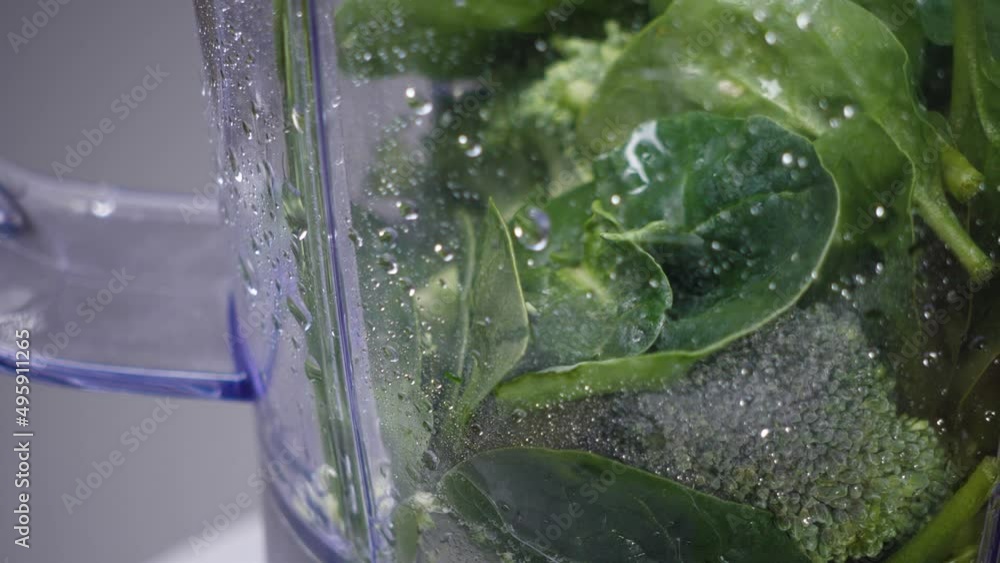 Green fresh smoothie in blender. Slow motion. Healthy eating concept. Green vegetables. Vegan. Detox. Green fresh smoothie in blender. Slow motion. Healthy eating concept. Green vegetables. Vegan. Detox.