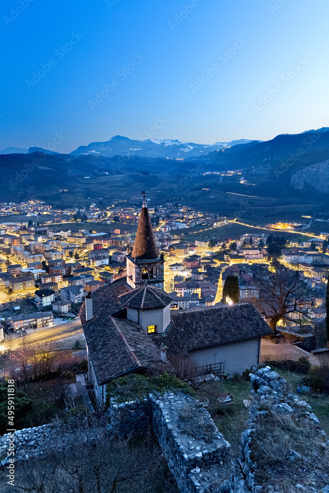 The church of Montalbano and the town of Mori. In the background the Brentonico plateau and the Mount Baldo. Vallagarina, Trento province, Trentino Alto-Adige, Italy, Europe.