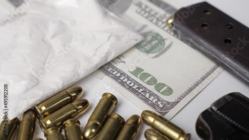 Weapons drugs and dollars. Tilt movement.Outside the law.  photo