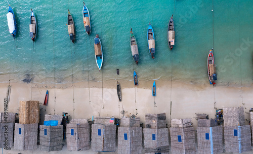 Aerial view of the Tropical island beach with seashore as the tropical island in a coral reef ,blue and turquoise sea with local boat background