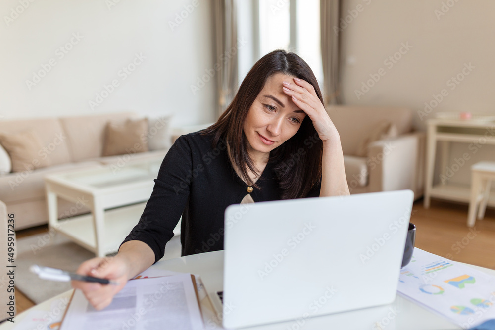 Asian woman working on laptop computer, smiling. Woman Working From Home On Laptop In Modern Apartment. Trendy woman working on laptop from home Asian woman working on laptop computer, smiling. Woman Working From Home On Laptop In Modern Apartment. Trendy woman working on laptop from home