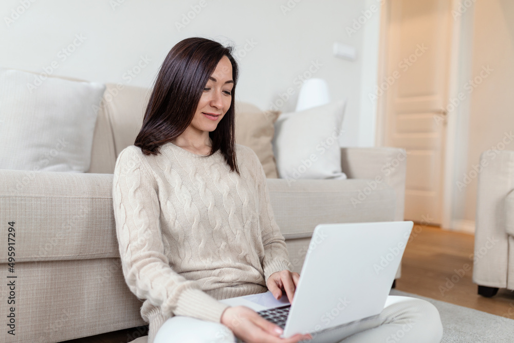 Portrait of casual asian woman relax sit on the floor use computer laptop. Thinking asian Freelance small business owner sme virtual, work from home concept. Portrait of casual asian woman relax sit on the floor use computer laptop. Thinking asian Freelance small business owner sme virtual, work from home concept.
