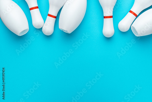 Fotografering Minimalist photo of bowling pins over turquoise blue background