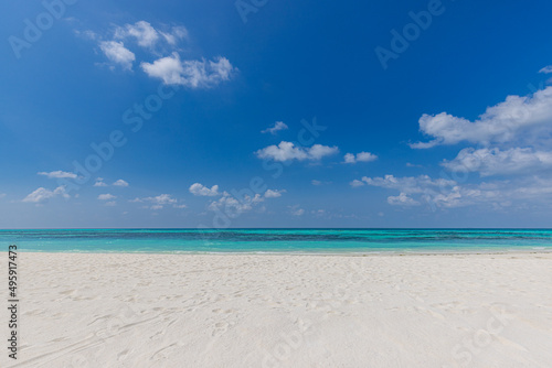 Closeup of sand on beach and blue summer sky. Panoramic beach landscape. Empty tropical beach and seascape. Orange and golden sunset sky  soft sand  calmness  tranquil relaxing sunlight  summer mood 