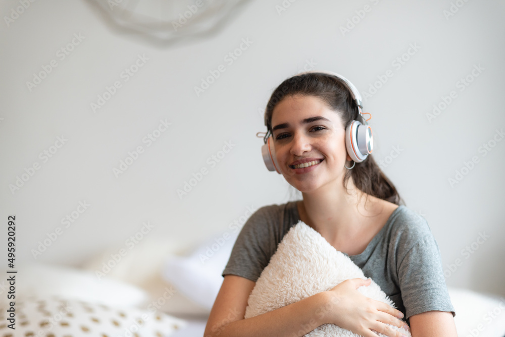Naklejka premium young pretty woman person are happy and enjoy with music by using earphone for listen a sound audio in bedroom at home, relax and fun lifestyle with a song melody, house entertainment headset concept