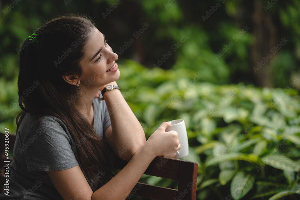 young beautiful woman person are happy and enjoy with coffee drink in the morning at home, relax lifestyle by holding coffee or tea cup at nature outdoor park, smile pretty girl with freedom time young beautiful woman person are happy and enjoy with coffee drink in the morning at home, relax lifestyle by holding coffee or tea cup at nature outdoor park, smile pretty girl with freedom time