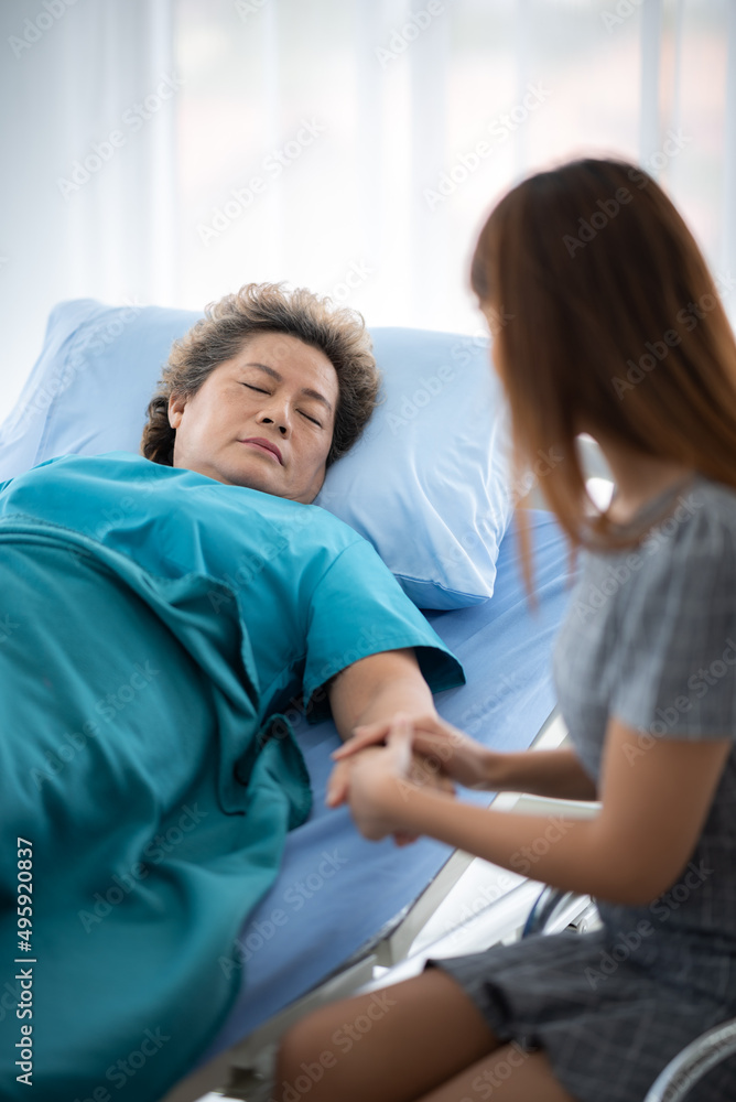 Fototapeta premium health insurance concept, young Asian woman are visit her senior family patient at hospital room, grandmother sitting on wheelchair are sick and having health care support by doctor and nurse