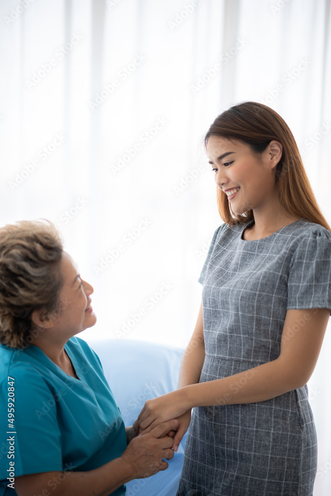 health insurance concept, young Asian woman are visit her senior family patient at hospital room, grandmother sitting on wheelchair are sick and having health care support by doctor and nurse health insurance concept, young Asian woman are visit her senior family patient at hospital room, grandmother sitting on wheelchair are sick and having health care support by doctor and nurse