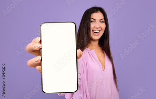 Beautiful Young Woman Demonstrating Big Blank Smartphone In Her Hand