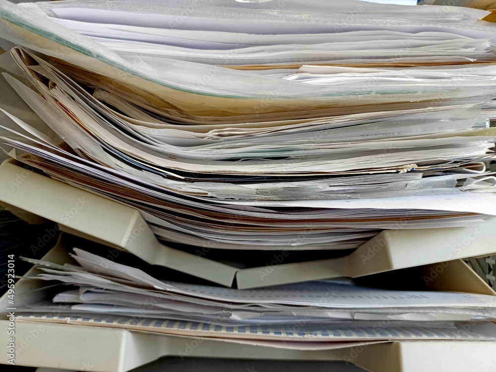 Big pile of news papers, documents, magazines on a shelf in the office. Big pile of news papers, documents, magazines on a shelf in the office.