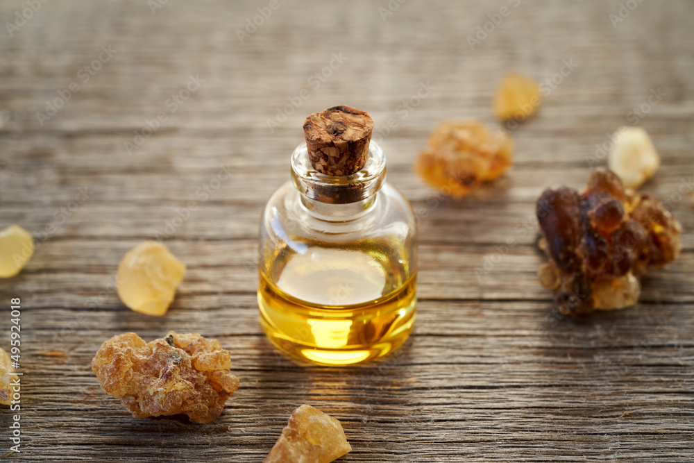 A bottle of frankincense essential oil with frankincense resin A bottle of frankincense essential oil with frankincense resin