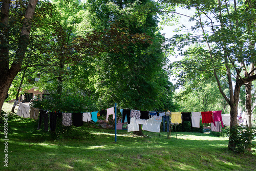 Drying clothes summer in the backyard of the house in the garden, warm summer day, hard and soft light