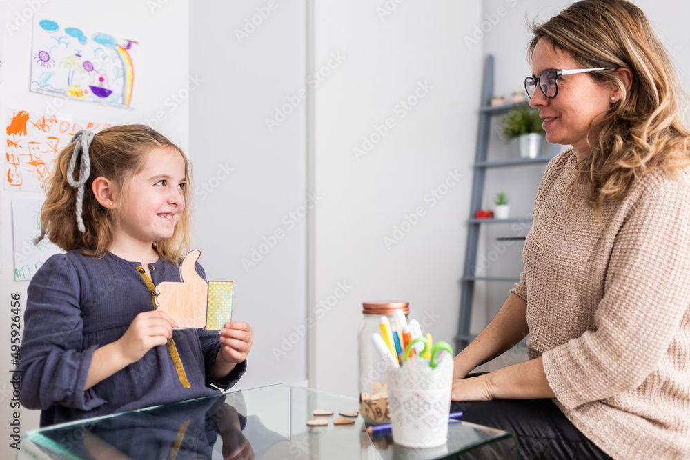 Girl showing like symbol to psychologist Girl showing like symbol to psychologist