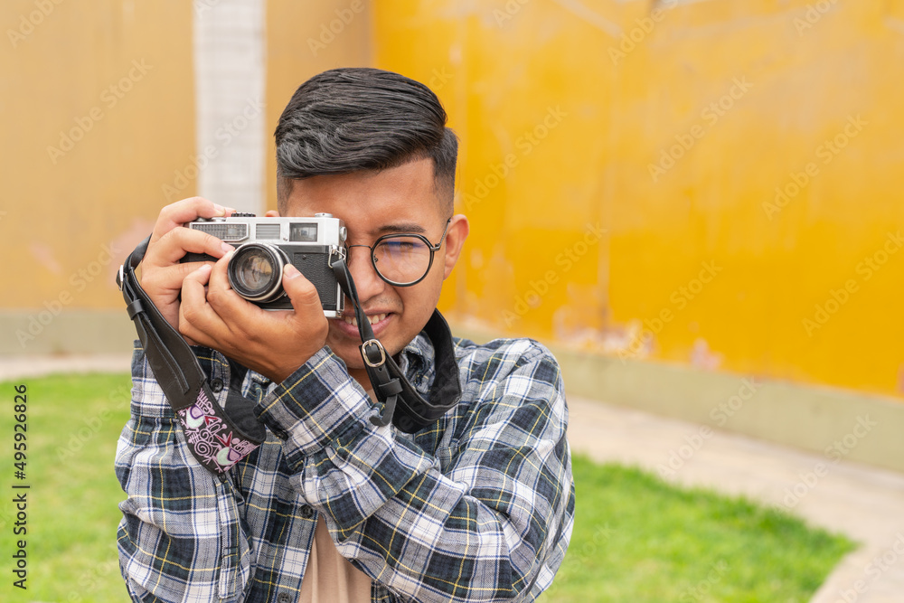 Ethnic photographer taking picture in park Ethnic photographer taking picture in park
