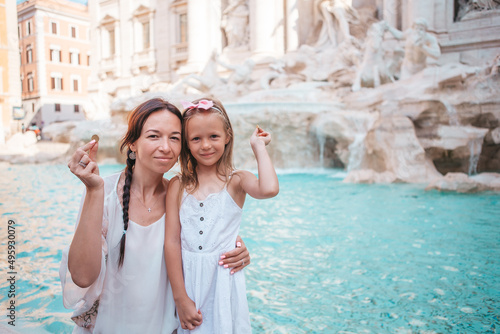 Young beautiful woman and little girl near fountain Fontana di Trevi