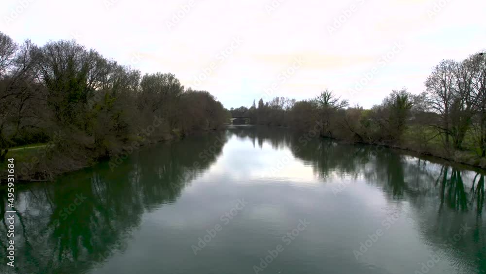 Approaching Pont Neuf bridge over the Charente River in Cognac France, with arched design, Aerial low flyover shot Approaching Pont Neuf bridge over the Charente River in Cognac France, with arched design, Aerial low flyover shot