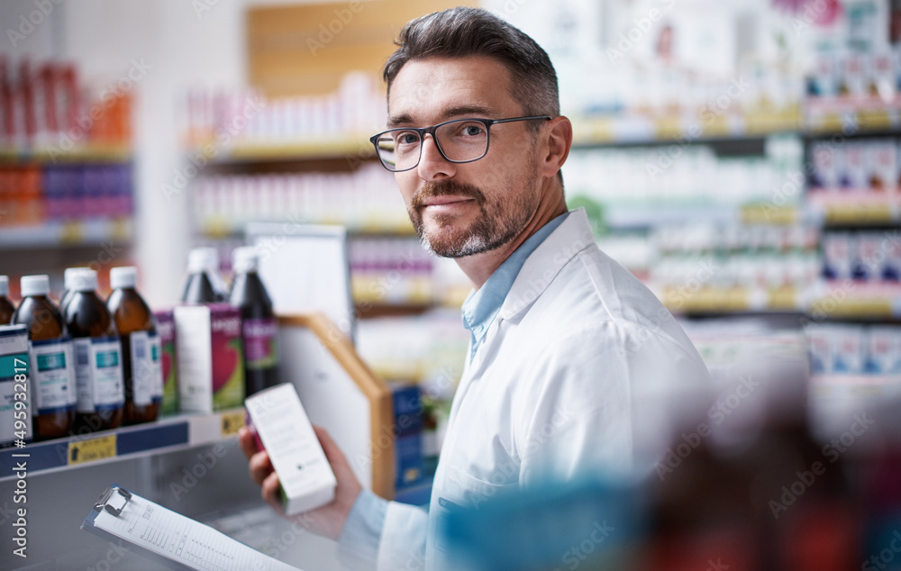 If anything will help you feel better, this will. Portrait of a mature pharmacist doing inventory in a pharmacy.