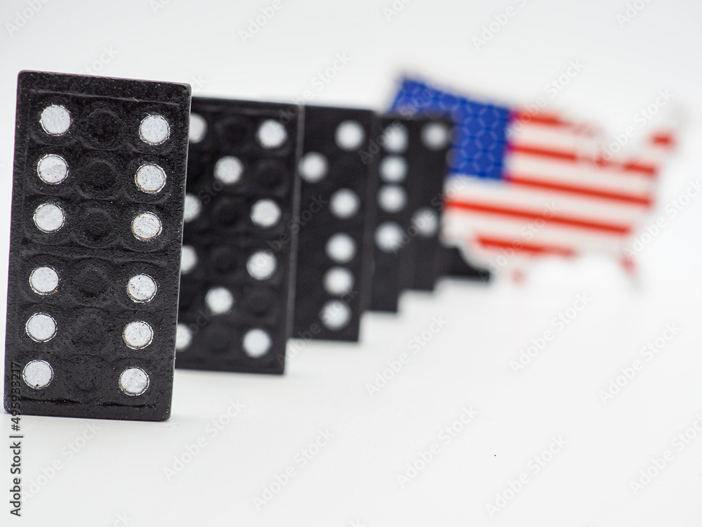 conceptual domino effect and american map with flag
