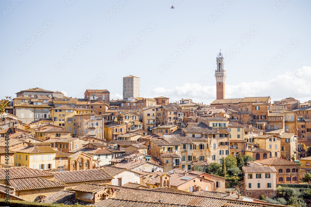 Cityscape of Siena town with bell tower of town hall in Tuscany region of Italy. Concept of visiting italian landmarks