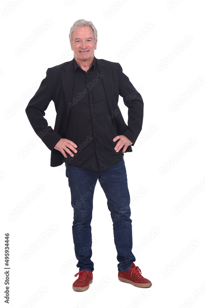 front view of man dressed in jeans sneakers and blazer with hands on hip on white background front view of man dressed in jeans sneakers and blazer with hands on hip on white background