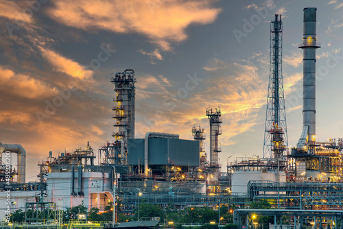 Oil and gas refinery plant area at sunrise near sea port or river