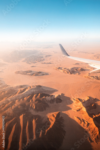View from the plane on the wing and mountains in the desert of Africa photo