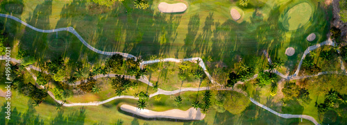 Fototapeta Naklejka Na Ścianę i Meble -  Aerial view drone shot of beautiful green golf field. Banner panorama background.
