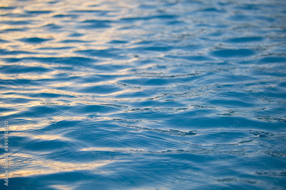 Closeup seascape surface of blue sea water with small ripple waves Closeup seascape surface of blue sea water with small ripple waves