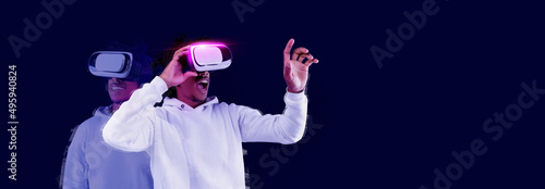 Excited young African American guy using VR glasses