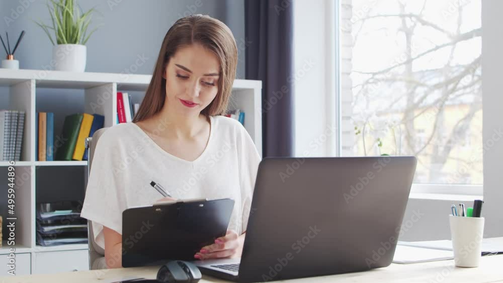 Young Woman Works at Home Office Using Computer. Workplace of Female Entrepreneur, Freelancer or Student. Remote Work and Education Concept. Young Woman Works at Home Office Using Computer. Workplace of Female Entrepreneur, Freelancer or Student. Remote Work and Education Concept.
